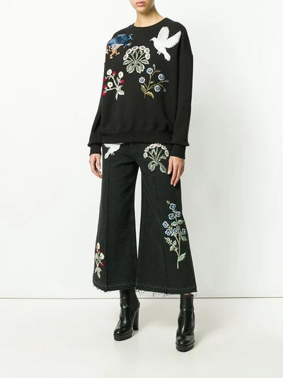 Shop Alexander Mcqueen Embroidered Patch Wide Leg Jeans - Black