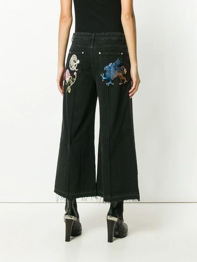 Shop Alexander Mcqueen Embroidered Patch Wide Leg Jeans - Black