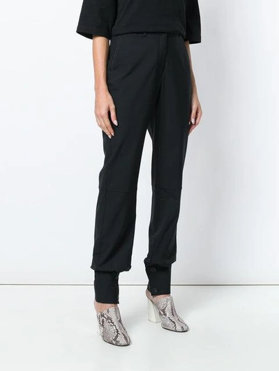 Shop Jw Anderson Button Cuff Trousers In Black