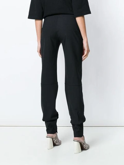 Shop Jw Anderson Button Cuff Trousers In Black