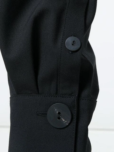 Shop Jw Anderson Button Cuff Trousers In Black