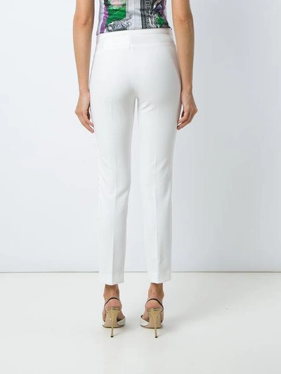 Shop Versace Skinny Stretch Trousers In White