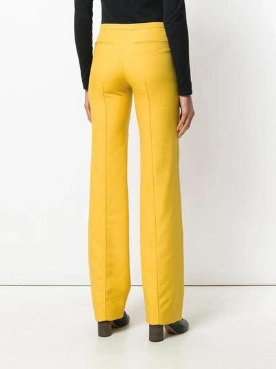 Shop Valentino Bow Detail Flared Trousers In 0c6