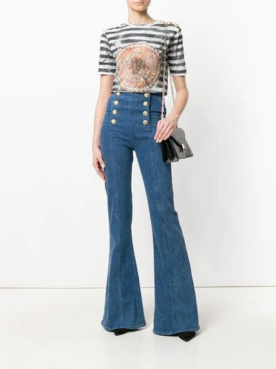 Shop Balmain Button-embellished Flared Jeans - Blue