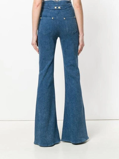 Shop Balmain Button-embellished Flared Jeans - Blue