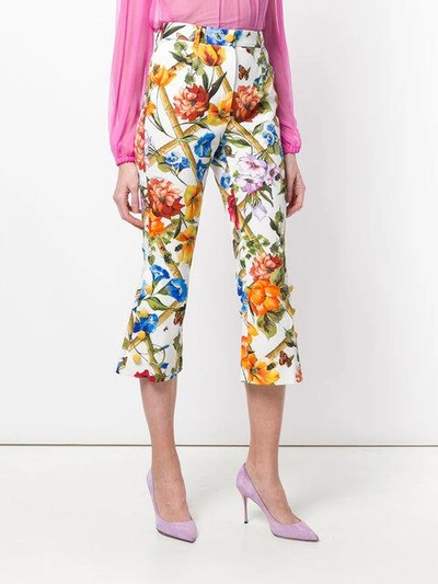 Shop Dolce & Gabbana Floral Print Flared Cropped Trousers In White