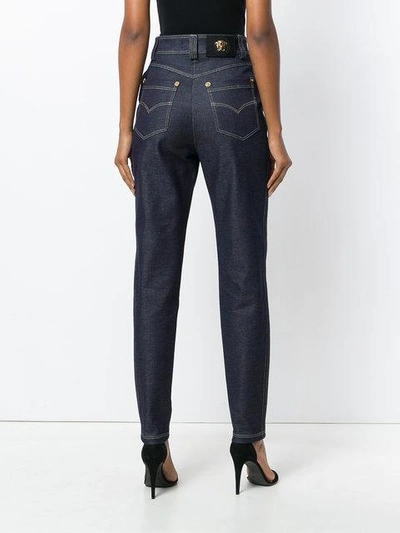 Shop Versace High Waisted Jeans In Blue