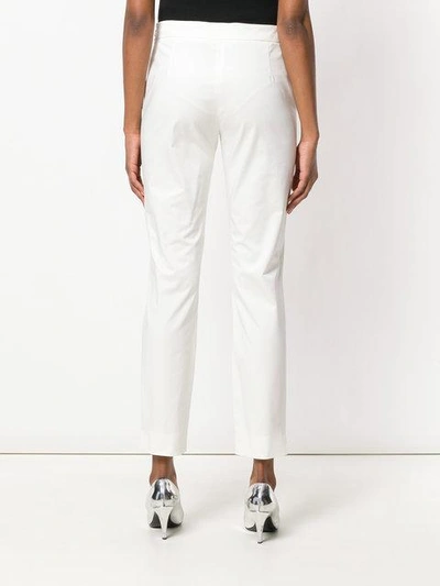 Shop Moschino High Waisted Crop Trousers In White
