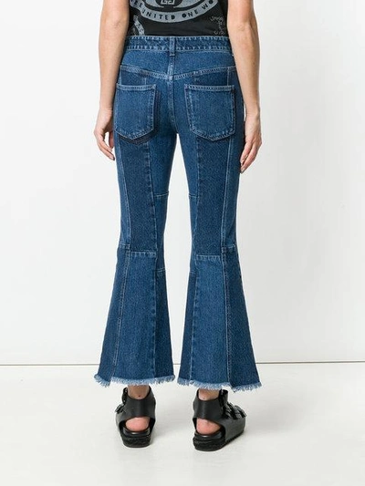 Shop Alexander Mcqueen Asymmetric Flared Cropped Jeans In Blue