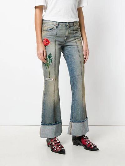 Shop Gucci Embroidered Flared Jeans With Turned Cuffs In Blue