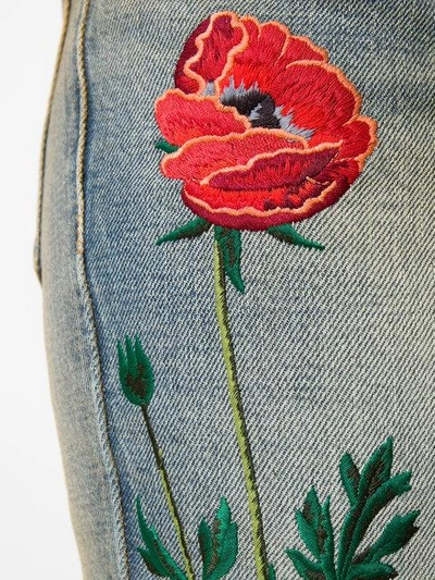 embroidered flared jeans with turned cuffs