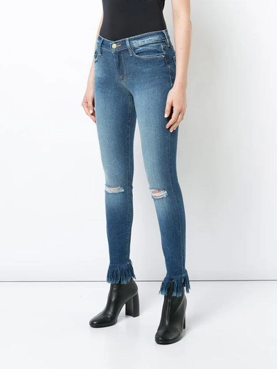 Shop Frame Frayed Ankle Jeans In Blue