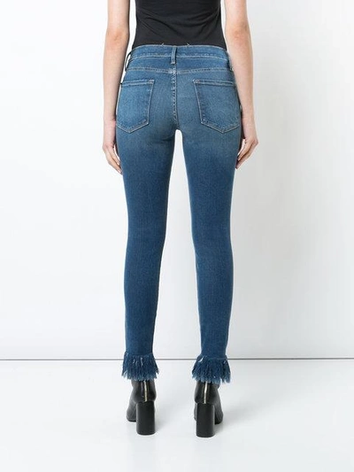 Shop Frame Frayed Ankle Jeans In Blue