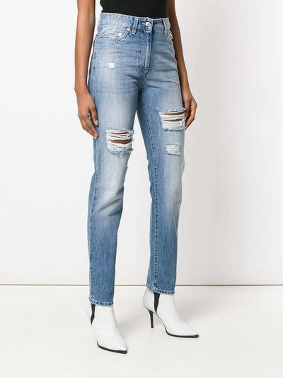 Shop Moschino Distressed Denim Trousers In Blue