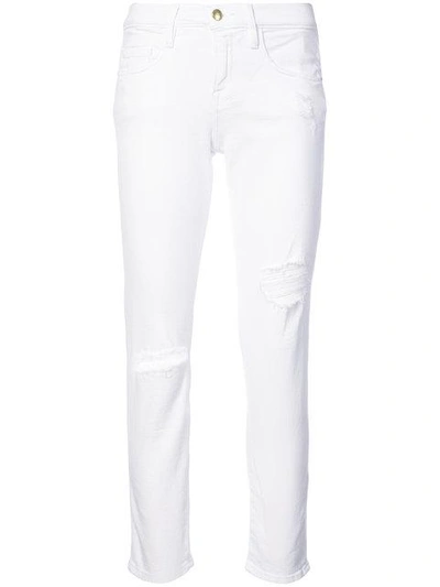 Shop Frame Distressed Skinny Jeans In White