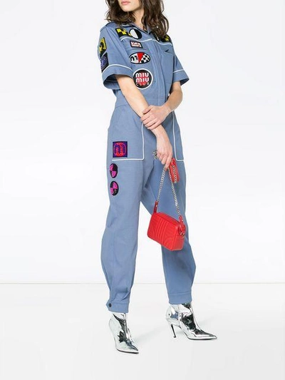 Shop Miu Miu Patch Front Jumpsuit In Blue