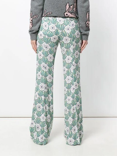 Shop Prada Floral Print Flared Trousers In Green