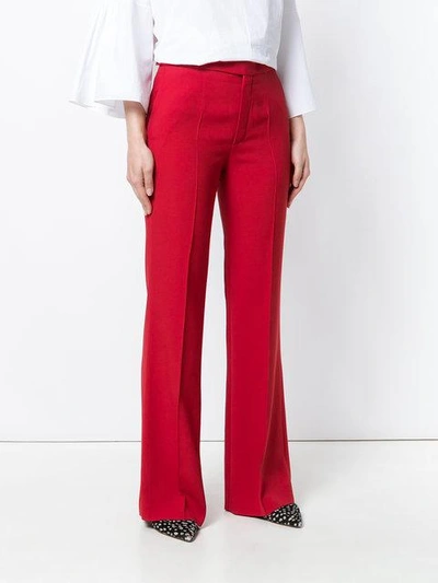 Shop Chloé High-rise Flared Trousers In Red