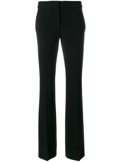 Shop Moschino High Waisted Flared Trousers In Black