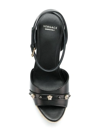 Shop Versace Wedge-sandalen Mit Medusa-nieten In Black
