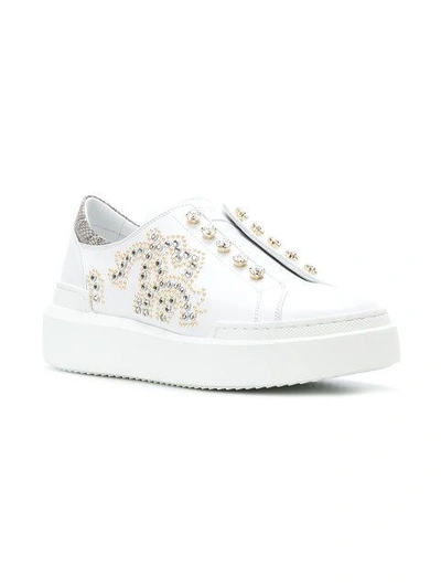 Shop Roberto Cavalli Crystal Embellished Slip-on Sneakers - White