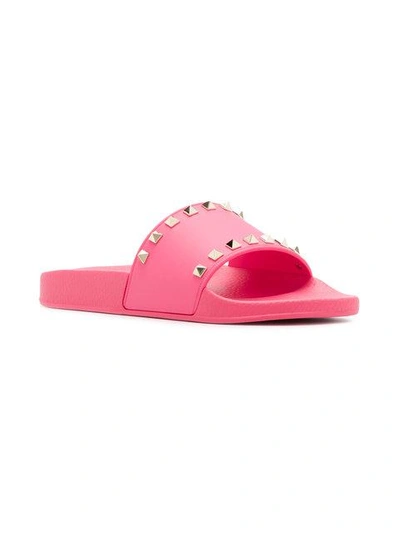 Shop Valentino Rockstud Slides In Pink