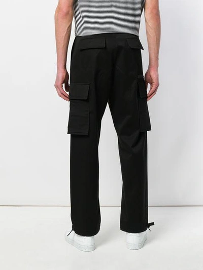 Shop Versace Multi-pocket Trousers In Black