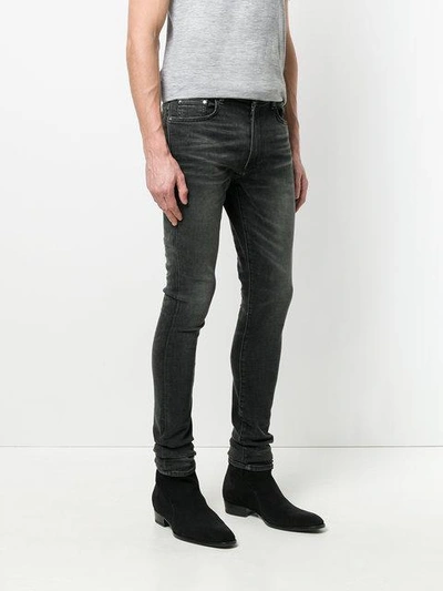 Shop Amiri Stack Skinny Jeans - Black