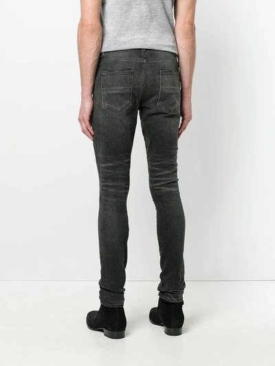 Shop Amiri Stack Skinny Jeans - Black