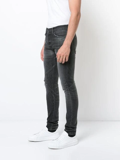 Shop John Elliott Ripped Skinny Jeans - Black