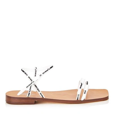 Shop Jimmy Choo Charlie Flat White Logo Rubber Strap Sandals In White/black/cuoio