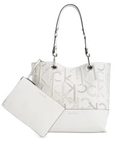 Shop Calvin Klein Sonoma Embossed Monogram Reversible Tote With Pouch In White/grey/silver