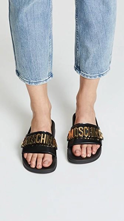 Shop Moschino Logo Sandals In Black/gold