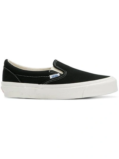 Shop Vans Classic Slip-on Sneakers - Black