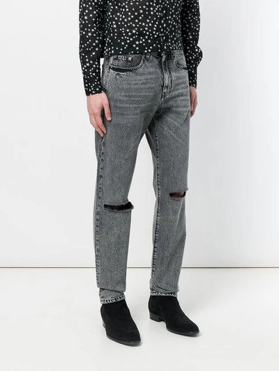 Shop Saint Laurent Ripped Stonewashed Jeans In Grey