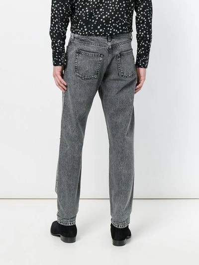 Shop Saint Laurent Ripped Stonewashed Jeans In Grey