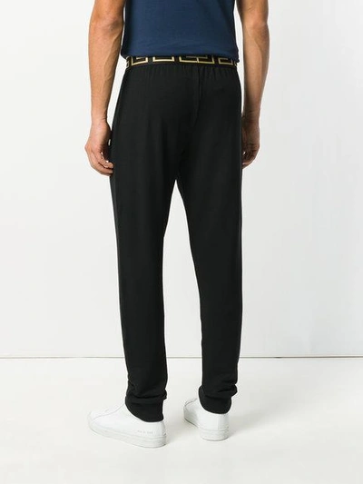 Shop Versace Greca Track Pants In Black