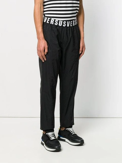 Shop Versus Logo Embroidered Trousers In Black