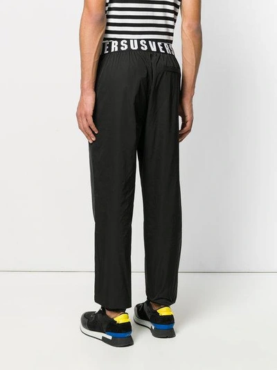 Shop Versus Logo Embroidered Trousers In Black