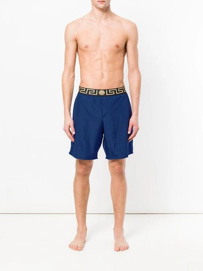Shop Versace Greek Key Waistband Swim Shorts - Blue