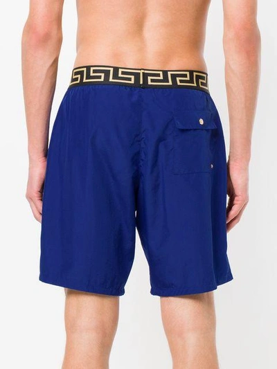 Shop Versace Greek Key Waistband Swim Shorts - Blue