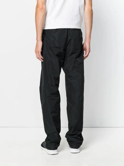 Shop White Mountaineering Wide Leg Track Pants In Black