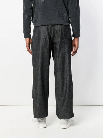 Shop White Mountaineering Wide Leg Trousers In Black