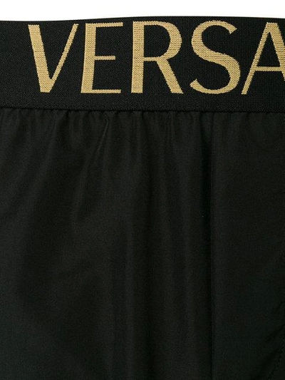 Shop Versace Logo Band Swim Shorts In Black