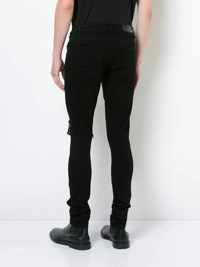 Shop Amiri Broken Jeans In Black