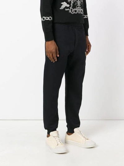 Shop Alexander Mcqueen Embroidered Track Trousers In Black