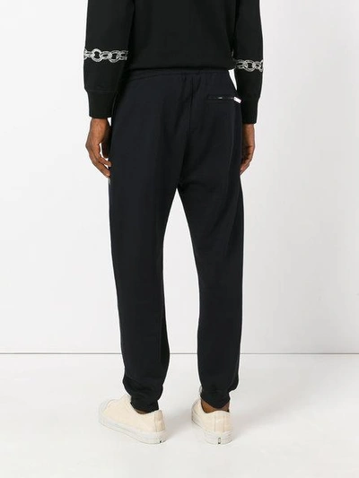 Shop Alexander Mcqueen Embroidered Track Trousers In Black