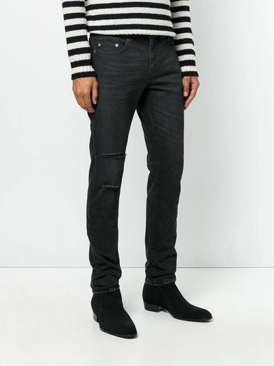 Shop Saint Laurent Vintage Effect Distressed Jeans In Black