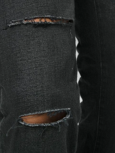 Shop Saint Laurent Vintage Effect Distressed Jeans In Black