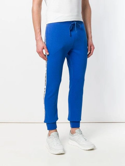 Shop Les Artists Logo Side Stripe Track Trousers In Blue